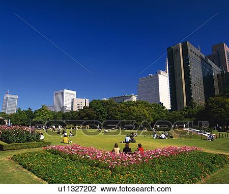 Stock Image - Hibiya Park and a business distric. Fotosearch