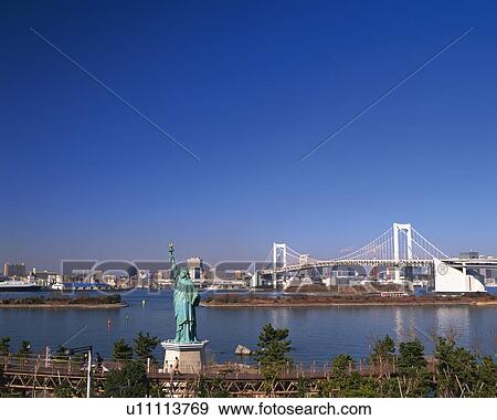 Stock Photo - Statue of Liberty and rainbow bridge. Fotosearch
