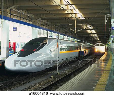 Stock Photograph - Shinkansen Running into Hakata Station. Fotosearch