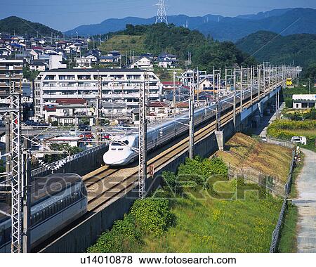 Stock Photo - Two Shinkansen Running in Fukuoka. Fotosearch