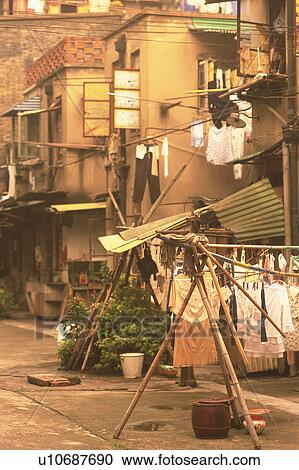 Stock Image -  a Little Street in Shanghai, With Several Clotheslines With Clothes Hanging Outdoors, Side View, Shanghai, China. Fotosearch