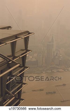 Stock Photograph -  a View From the Jin Mao Tower, Looking Upon a River With Several Boats and a Large Number of Buildings, High Angle View, Shanghai, China. Fotosearch