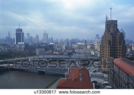 Several Buildings and a Bridge Spreading Over a River Under a Grey Sky, High Angle View, Shanghai, China View Large Photo Image Stock Photo - Several Buildings and a Bridge Spreading Over a River Under a Grey Sky, High Angle View, Shanghai, China. Fotosearch