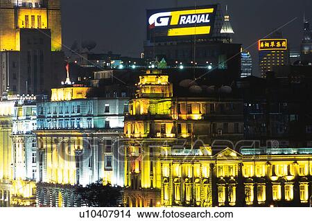 Picture -  Several Buildings in Shanghai at Night, Illuminated in Different Colors, Front View, Shanghai, China. Fotosearch