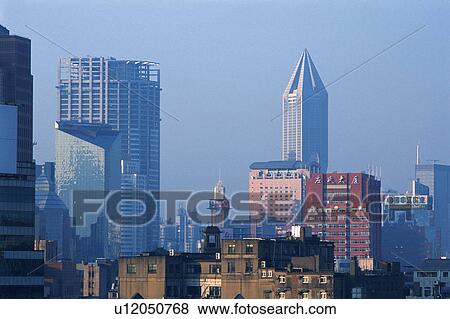Stock Photo -  Several Buildings of Shanghai Under a Blue Sky, Front View, Shanghai, China. Fotosearch