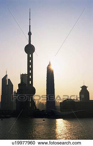 Several Shanghai Buildings By Sunset, the Oriental Pearl Tower also Visual, Low Angle View, Lens Flare, Shanghai, China View Large Photo Image Stock Image - Several Shanghai Buildings By Sunset, the Oriental Pearl Tower also Visual, Low Angle View, Lens Flare, Shanghai, China. Fotosearch