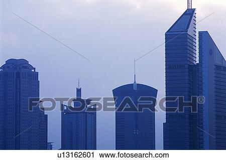 Several Skyscraper Standing Next to Each Other Under a Cloudy Sky, Front View, Shanghai, China View Large Photo Image Stock Image - Several Skyscraper Standing Next to Each Other Under a Cloudy Sky, Front View, Shanghai, China. Fotosearch