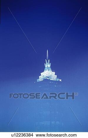Picture -  the Jin Mao Tower By Night, the Top Of the Tower Glowing White Under a Dark Blue Sky, Low Angle View, Shanghai, China. Fotosearch