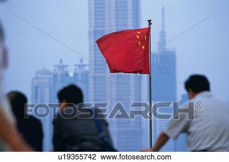 Stock Image -  the National Chinese Flag Among Some Tourists Looking at a Scenery in Shanghai, Front View, Differential Focus, Shanghai, China. Fotosearch