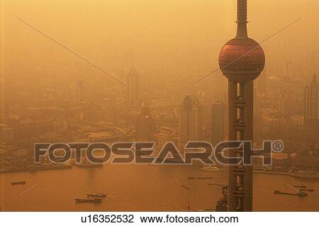 Stock Image -  the Oriental Pearl TV Tower By Sunset Among of a Lot of Other Buildings, High Angle View, Shanghai, China. Fotosearch