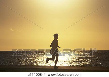 a Woman Jogging at the Beach By Sunset, Side View, Hawaii, USA, Toned Image, Side View View Large Photo Image Stock Image - a Woman Jogging at the Beach By Sunset, Side View, Hawaii, USA, Toned Image, Side View. Fotosearch