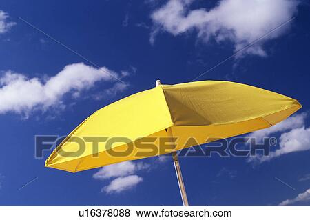 Stock Photo -  a Yellow-colored Sunshade Under a Blue Sky, Low Angle View, Hawaii, USA. Fotosearch