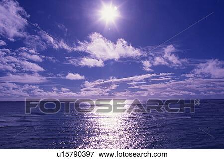 Stock Photo -  the Sun Shining Brightly, the Ocean Reflecting Its Beams, Front View, Lens Flare, Hawaii, USA. Fotosearch