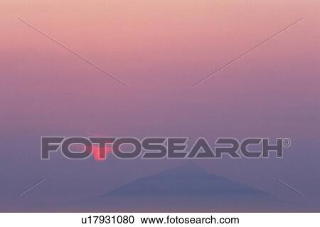Stock Image -  a Mountain, Surrounded By a Red-colored Sky, Front View, Differential Focus, Hokkaido Prefecture, Japan. Fotosearch