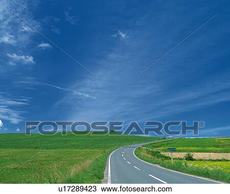 a Road, Surrounded By a Green Flat Land Under a Blue Sky, Hokkaido Prefecture, Japan View Large Photo Image Stock Image - a Road, Surrounded By a Green Flat Land Under a Blue Sky, Hokkaido Prefecture, Japan. Fotosearch