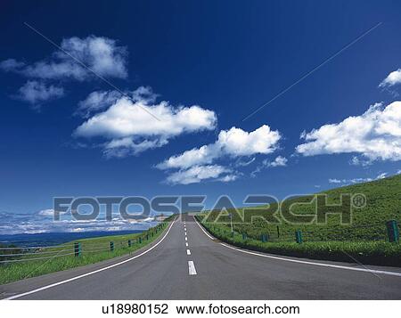 a Road, Surrounded By Green Land and the Sea, Under a Blue Sky, Hokkaido Prefecture, Japan View Large Photo Image Stock Image - a Road, Surrounded By Green Land and the Sea, Under a Blue Sky, Hokkaido Prefecture, Japan. Fotosearch