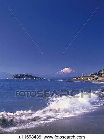 Stock Photography - Distant view of Mt. Fuji from beach in Kamakura city, Kanagawa prefecture, Japan, copy space. Fotosearch