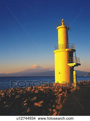 Picture - Lighthouse and Mt. Fuji beyond the sea, low angle view, Toda village, Shizuoka prefecture, Japan, copy space. Fotosearch