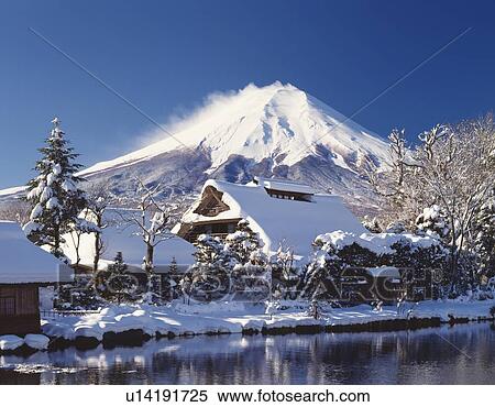 Stock Photography - Mt. Fuji and houses covered with snow, Oshino village, Yamanashi prefecture, Japan. Fotosearch