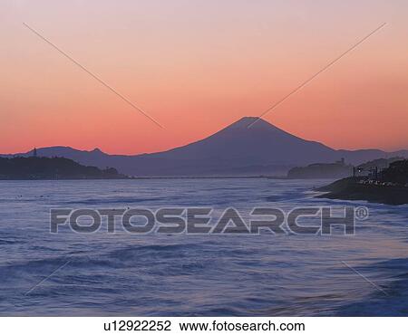 Stock Image - Mt. Fuji beyond the sea in the evening, Kamakura city, Kanagawa prefecture, Japan. Fotosearch