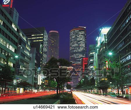 Stock Image - JR Central Towers, Nagoya City, Japan, Low Angle View, Lens Flare, Long Exposure. Fotosearch