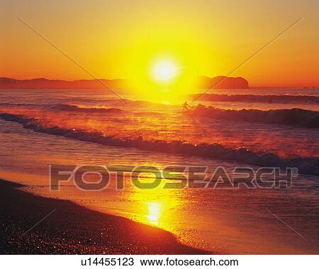 Stock Image - Sunset of Tsujido Beach, Shonan, Kanagawa Prefecture, Japan, Front View, Lens Flare. Fotosearch