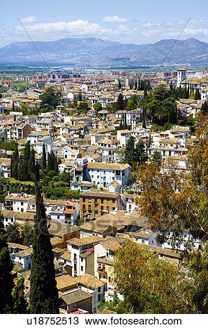Stock Image - A view of a Spanish city with mountains in the background . Fotosearch