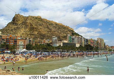 Stock Photograph - Spain, Alicante, Summer, Beach, Sand, Shore, People. Fotosearch