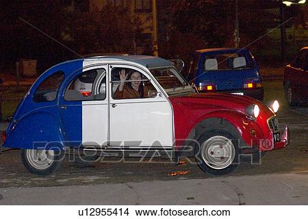 Picture - French Peugeot red white and blue with woman driver waving. Fotosearch