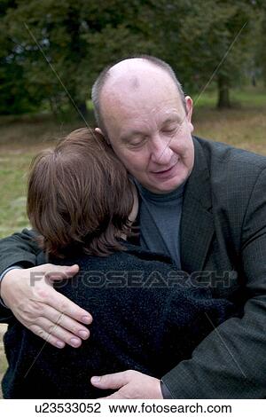 Stock Image - Friends hugging greeting. Fotosearch