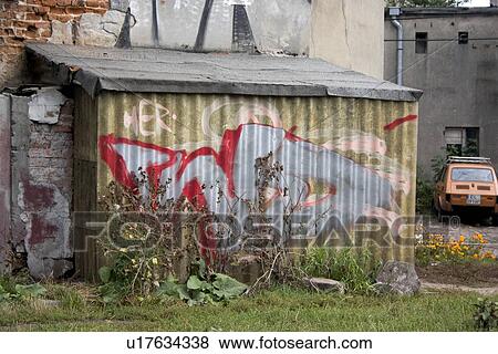 Stock Photo - Graffiti on tin storage building. Fotosearch