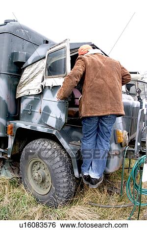 Man climbing into a military truck View Large Photo Image Stock Photograph - Man climbing into a military truck. Fotosearch
