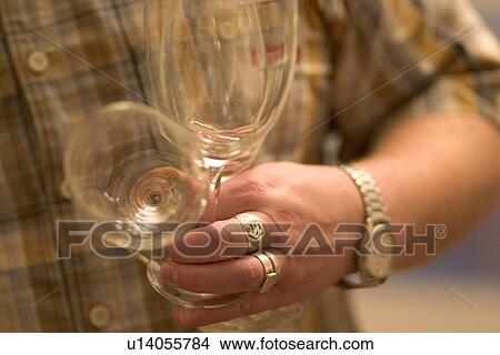 Picture - Man holding wine glasses. Fotosearch
