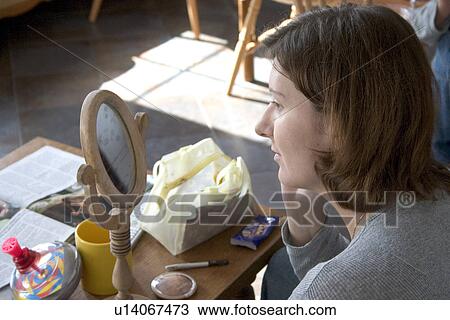 Stock Image - Polish woman applying makeup. Fotosearch