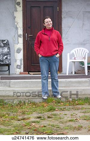 Polish woman smiling and standing in front of her unfinished country home View Large Photo Image Stock Photograph - Polish woman smiling and standing in front of her unfinished country home. Fotosearch