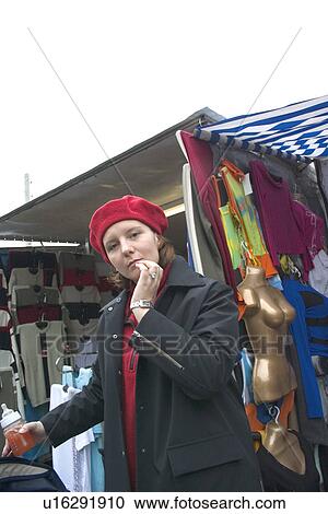Stock Image - Thoughtful Polish woman shopper at the Balucki Rynek market. Fotosearch