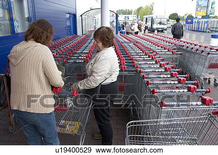 Stock Photo - Women shoppers selecting a basket., Lodz, Central Poland. Fotosearch