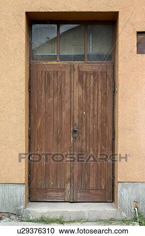 Stock Image - Wood door with glass transom, Rawa Mazowiecka, Central Poland. Fotosearch