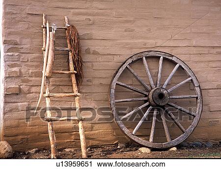 Stock Image - Ladder and wheel in the wild west. Fotosearch