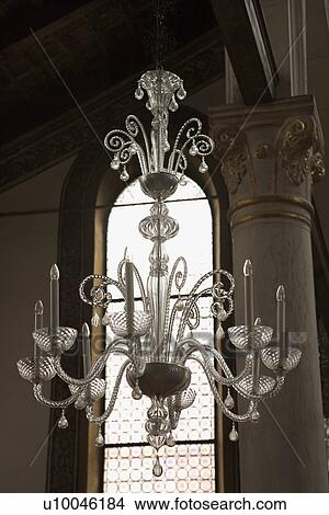 Decorative ornate crystal chandelier hanging from ceiling. View Large Photo Image Picture - Decorative ornate crystal chandelier hanging from ceiling.. Fotosearch