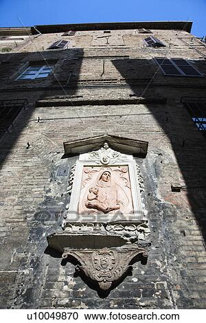 Stock Image - Outdoor relief of Virgin and Child, Italy. . Fotosearch