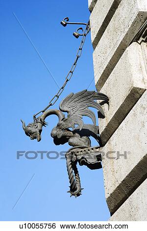 Stock Photograph - Winged gargoyle chained to wall.. Fotosearch