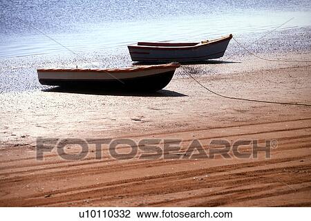 Stock Image - West River beach and boats on red sand. Fotosearch