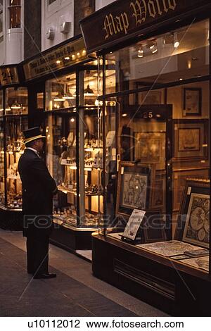 Stock Image - Burlington shopping Arcade with doorman and shop windows. Fotosearch
