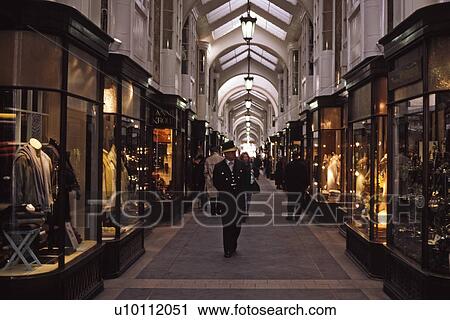 Stock Image - Burlington shopping Arcade with doorman and shop windows. Fotosearch