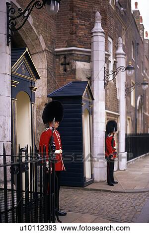 Stock Image - Guards on duty and St James Palace London. Fotosearch