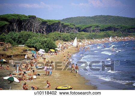 Stock Image - Bathers on beach with waves. Fotosearch