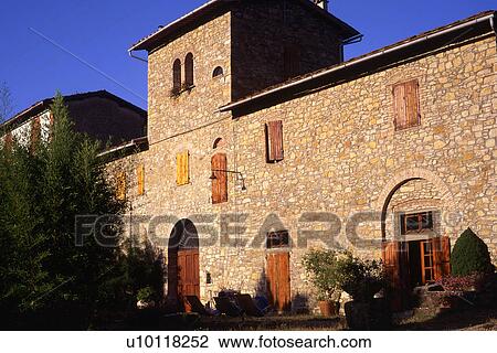 Stock Image - stone farmhouse with wood shuttered windows and doors Tuscany Italy. Fotosearch