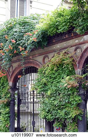 Stock Photo - Entrance to courtyard with wrought-iron gate. Fotosearch