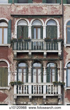 Stock Photo - balcony and shuttered arched windows of palazzo along Grand Canal. Fotosearch